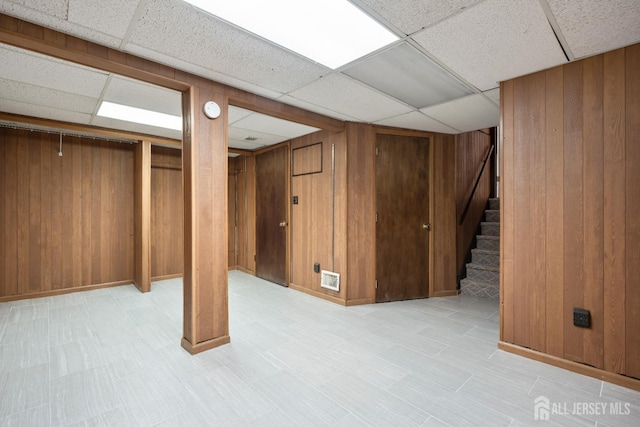 14 Bosko Dr, East Brunswick, NJ 08816 - finished basement featuring a drop ceiling, light floors, wooden walls, and stairway
