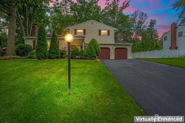 14 Bosko Dr, East Brunswick, NJ 08816 - traditional-style home featuring an attached garage, asphalt driveway, and a chimney