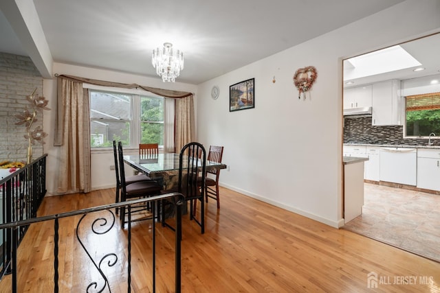 14 Bosko Dr, East Brunswick, NJ 08816 - dining room with a chandelier, healthy amount of natural light, and light wood-style floors
