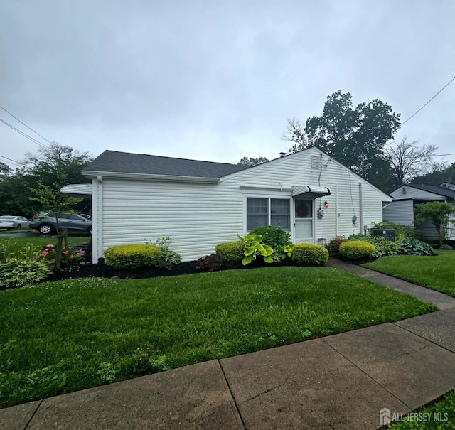 91 Grant Ave, Fords, NJ 08863 - view of front facade with a front lawn and a shingled roof