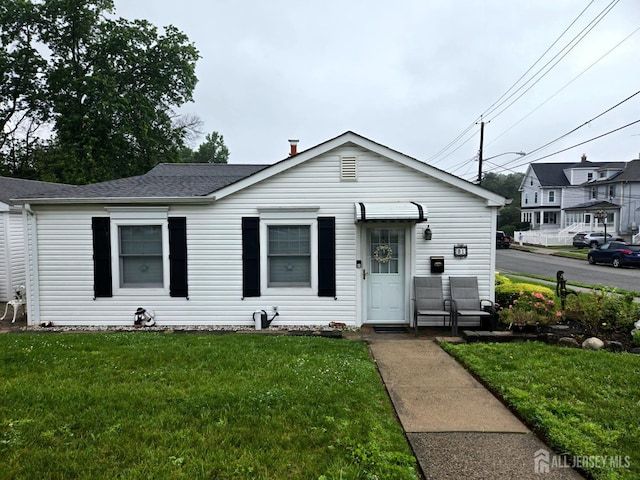 91 Grant Ave, Fords, NJ 08863 - view of front of house with a front yard and a shingled roof