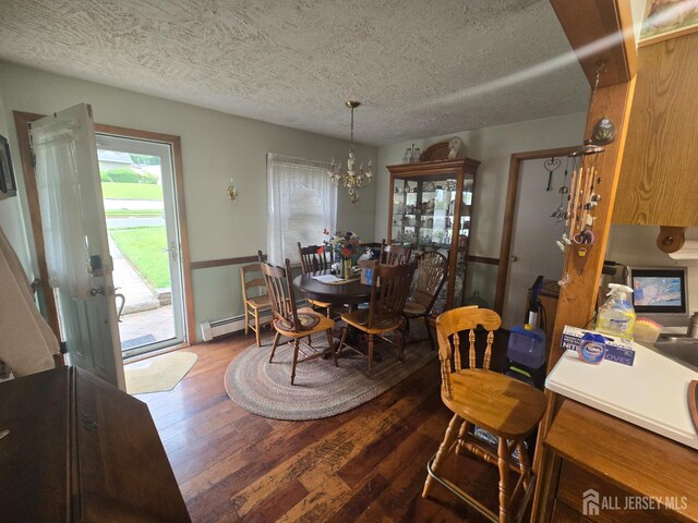 91 Grant Ave, Fords, NJ 08863 - dining area with a textured ceiling, a chandelier, baseboard heating, and hardwood / wood-style flooring
