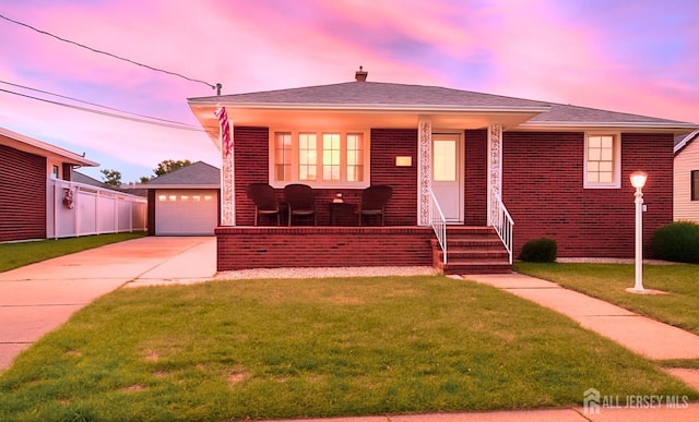 13 Olchaskey Ave, South River, NJ 08882 - view of front of home featuring concrete driveway, a yard, an outbuilding, covered porch, and brick siding