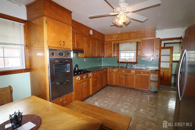 13 Olchaskey Ave, South River, NJ 08882 - kitchen with appliances with stainless steel finishes, brown cabinetry, under cabinet range hood, and ceiling fan