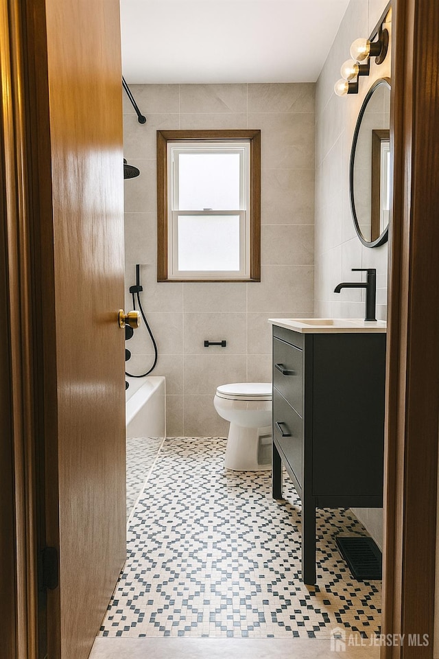 13 Olchaskey Ave, South River, NJ 08882 - bathroom featuring tile walls, shower / washtub combination, and vanity