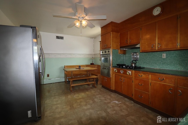 13 Olchaskey Ave, South River, NJ 08882 - kitchen featuring appliances with stainless steel finishes, brown cabinetry, under cabinet range hood, and a ceiling fan