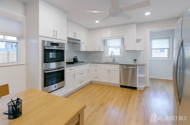 13 Olchaskey Ave, South River, NJ 08882 - kitchen with stainless steel appliances, light wood finished floors, white cabinetry, a ceiling fan, and recessed lighting