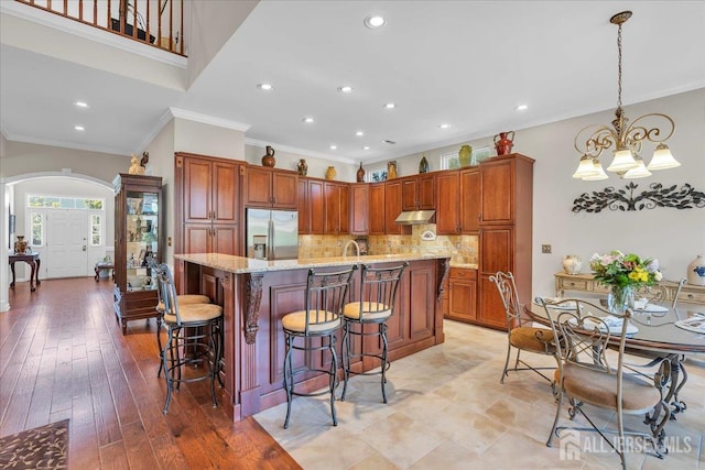 1 Ballybunion Dr, Monroe, NJ 08831 - kitchen featuring stainless steel refrigerator with ice dispenser, ornamental molding, arched walkways, under cabinet range hood, and recessed lighting