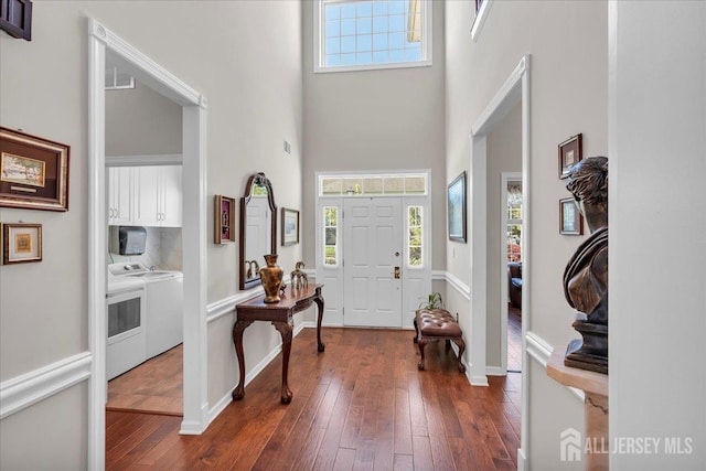 1 Ballybunion Dr, Monroe, NJ 08831 - foyer featuring washer and clothes dryer, a high ceiling, dark wood-style flooring, and baseboards
