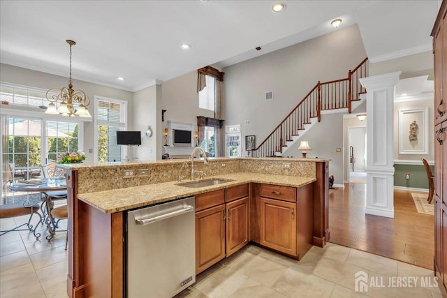 1 Ballybunion Dr, Monroe, NJ 08831 - kitchen with stainless steel dishwasher, a sink, hanging light fixtures, brown cabinets, and crown molding