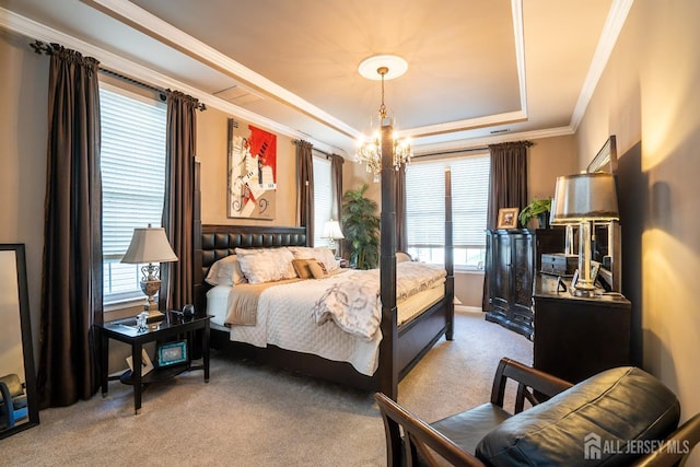 carpeted bedroom with a chandelier, a raised ceiling, and ornamental molding