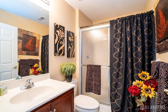 bathroom with a shower with door, toilet, and vanity