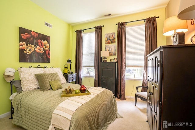 bedroom featuring light colored carpet