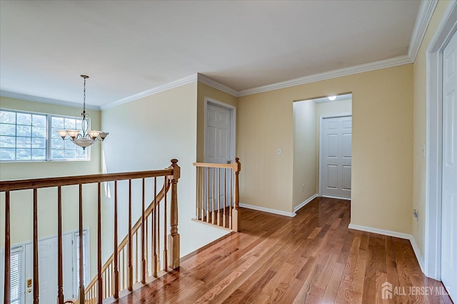 37 Muirfield Blvd, Monroe, NJ 08831 - hall featuring a chandelier, an upstairs landing, wood finished floors, and crown molding