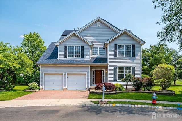 37 Muirfield Blvd, Monroe, NJ 08831 - traditional-style home with roof mounted solar panels, decorative driveway, a front lawn, and a garage