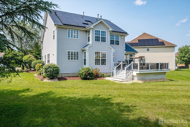 37 Muirfield Blvd, Monroe, NJ 08831 - back of property featuring roof mounted solar panels, a wooden deck, and a yard