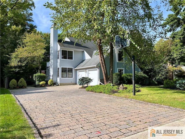 view of front of property with a front yard and a garage