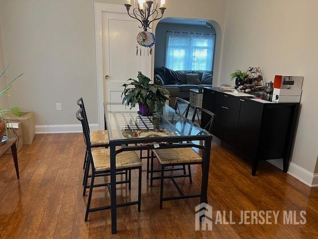 79 Davidson Mill Rd, South Brunswick, NJ 08902 - dining area featuring wood finished floors, baseboards, and arched walkways
