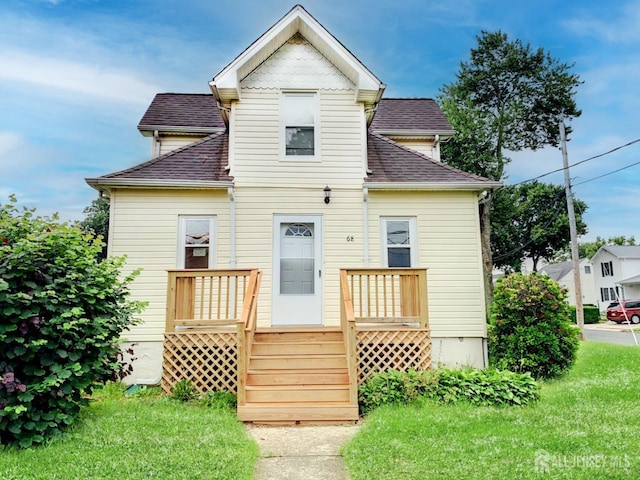 rear view of property with a yard