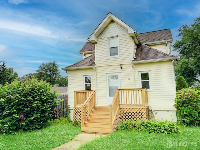 back of property featuring a yard