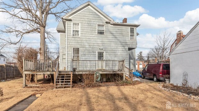 back of property featuring a wooden deck