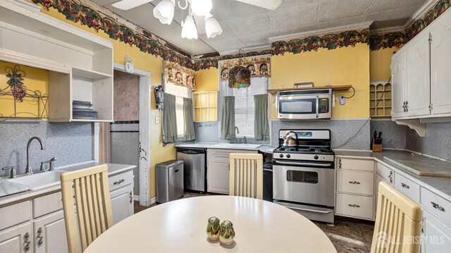 kitchen featuring ceiling fan, white cabinets, and appliances with stainless steel finishes