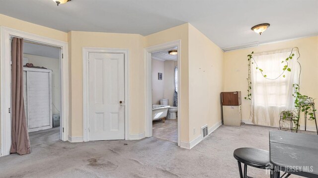 corridor with light colored carpet