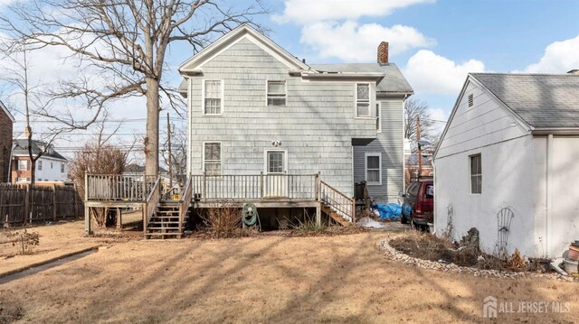 back of property featuring a wooden deck