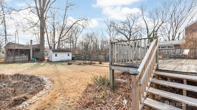 view of yard with a wooden deck and a shed