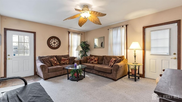 carpeted living room with ceiling fan and plenty of natural light