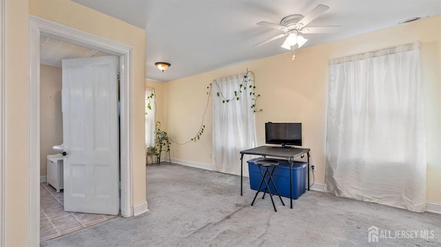 miscellaneous room featuring light carpet and ceiling fan