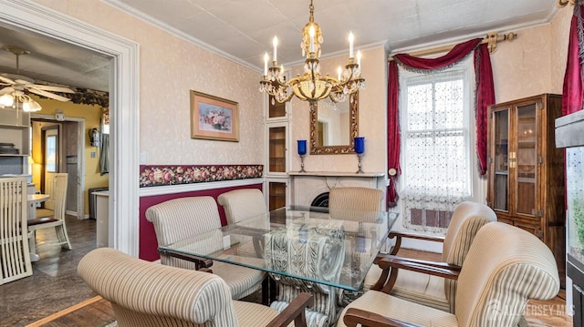 dining space with crown molding and ceiling fan with notable chandelier