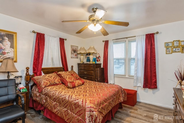 bedroom with hardwood / wood-style floors and ceiling fan