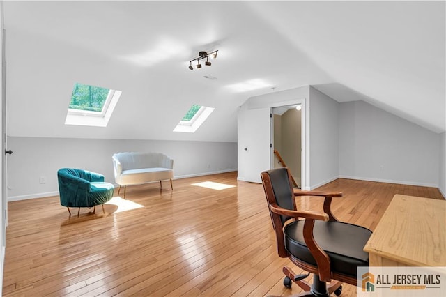 161 Metuchen Ave, Woodbridge Proper, NJ 07095 - home office featuring a skylight, wood-type flooring, lofted ceiling, and baseboards