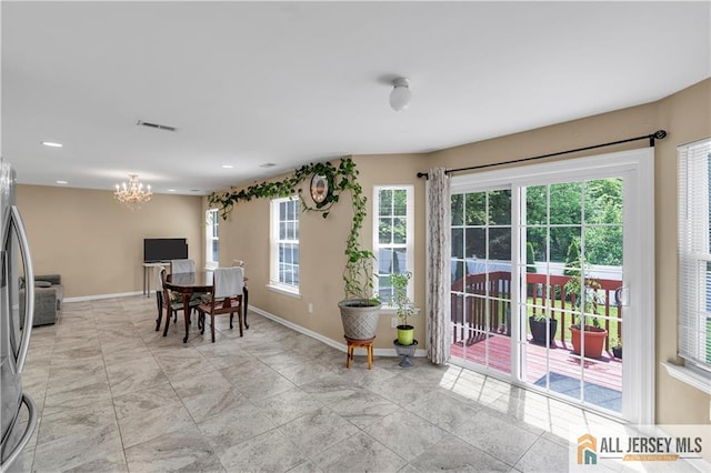 dining room featuring a chandelier, plenty of natural light, baseboards, and recessed lighting