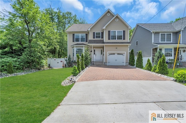 view of front of home with decorative driveway, a front lawn, and a garage