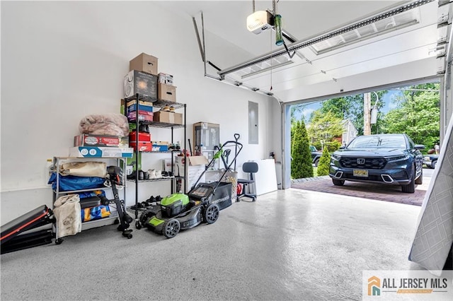 garage with electric panel and a garage door opener