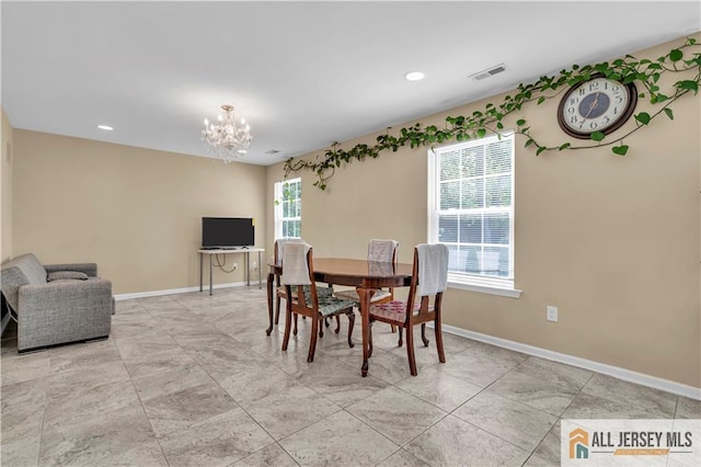 dining area featuring a chandelier, baseboards, and recessed lighting