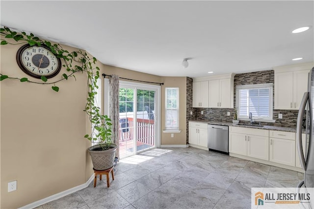 161 Metuchen Ave, Woodbridge Proper, NJ 07095 - kitchen featuring appliances with stainless steel finishes, a sink, baseboards, tasteful backsplash, and recessed lighting