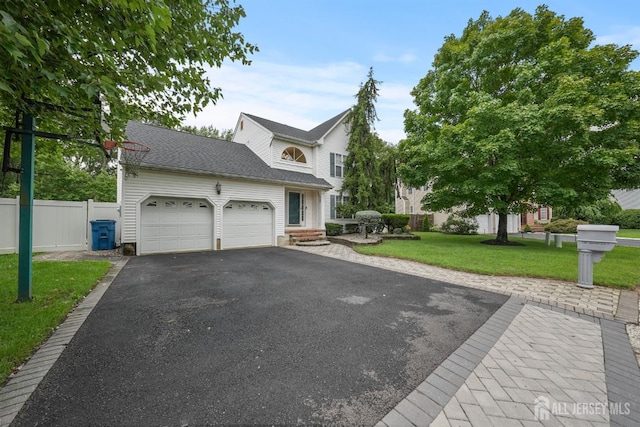 view of front of house featuring a front yard and a garage