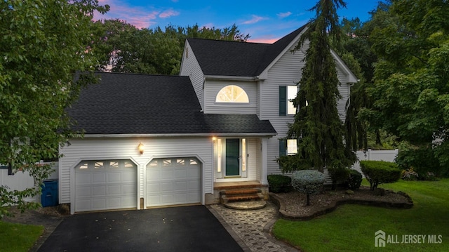 view of front property with a lawn and a garage