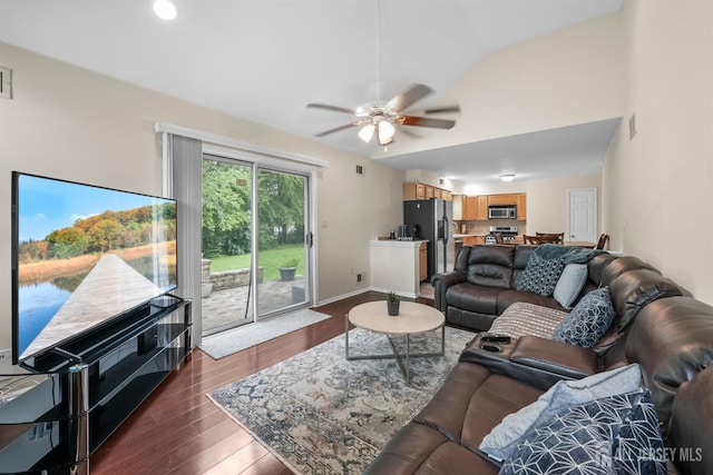 living room featuring lofted ceiling, ceiling fan, and dark hardwood / wood-style floors