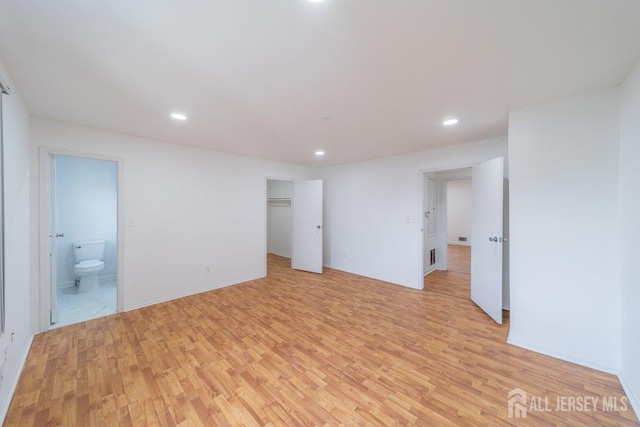 spare room featuring light wood-type flooring and recessed lighting