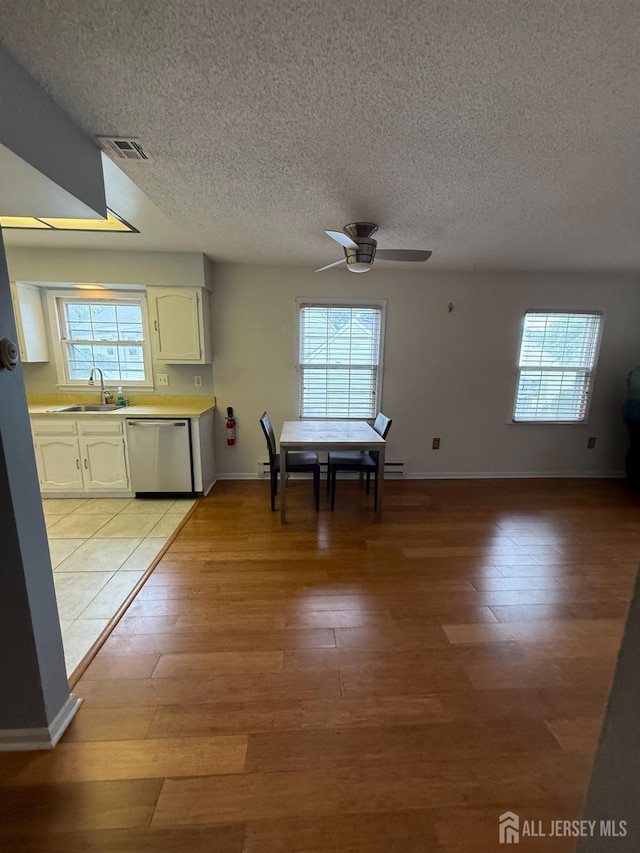 469-O New Haven Way, Monroe, NJ 08831 - unfurnished dining area featuring a sink, a textured ceiling, light wood-type flooring, a ceiling fan, and healthy amount of natural light