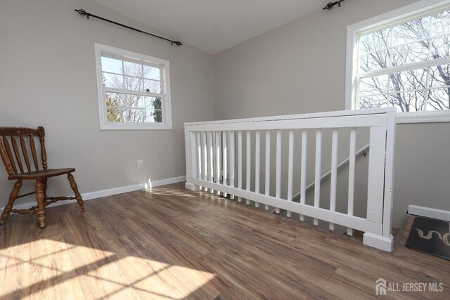 sitting room with lofted ceiling and hardwood / wood-style floors