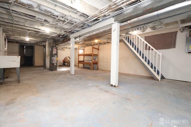 basement with electric panel and water heater