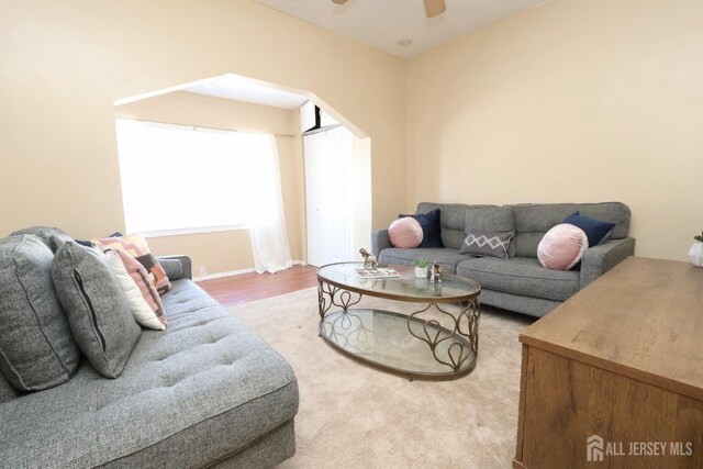 living room featuring hardwood / wood-style flooring and ceiling fan