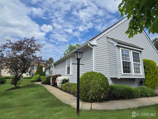 view of home's exterior with a lawn