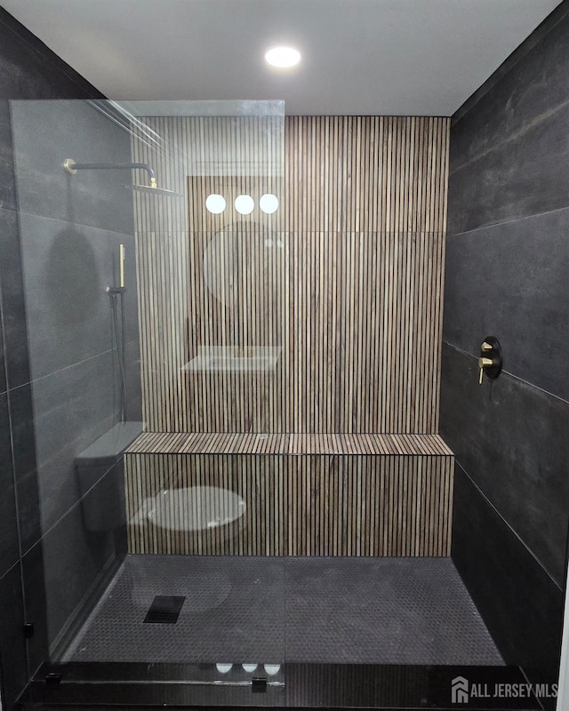bathroom with tiled shower