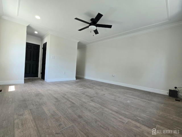 spare room with ceiling fan, crown molding, wood finished floors, baseboards, and recessed lighting